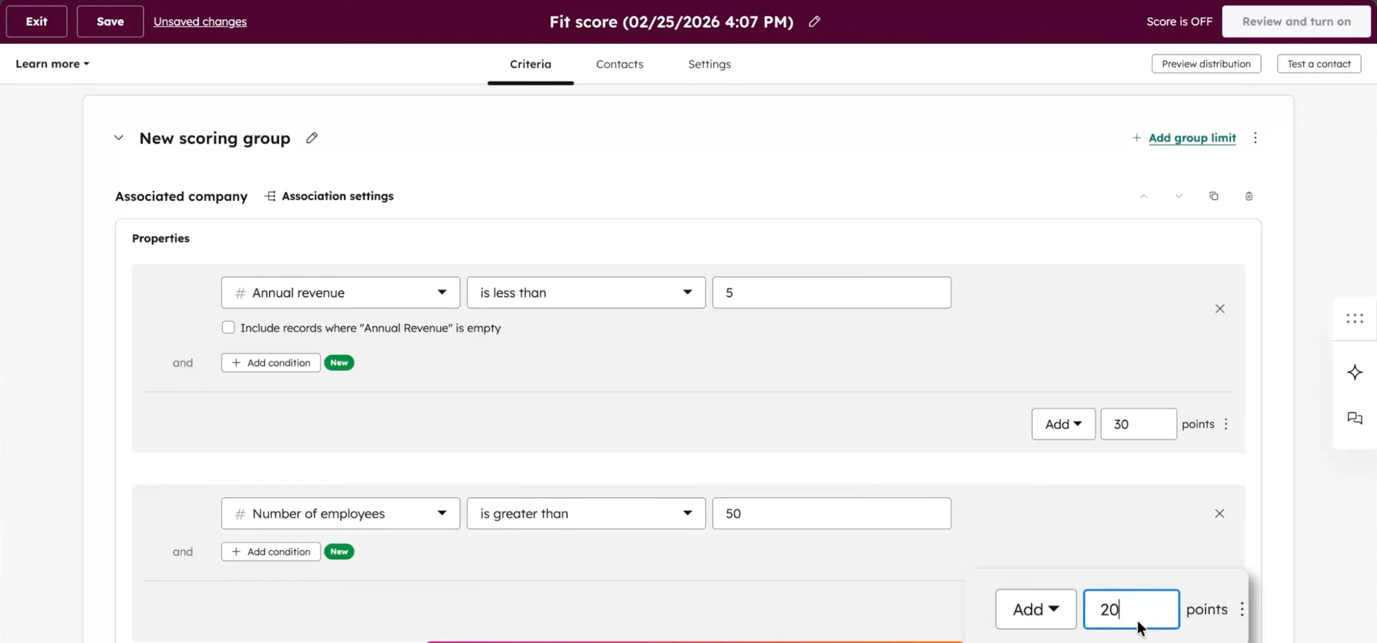 The HubSpot fit score builder: two scoring rules on an associated company, each pairing a property and a comparison with a points value typed into a box.